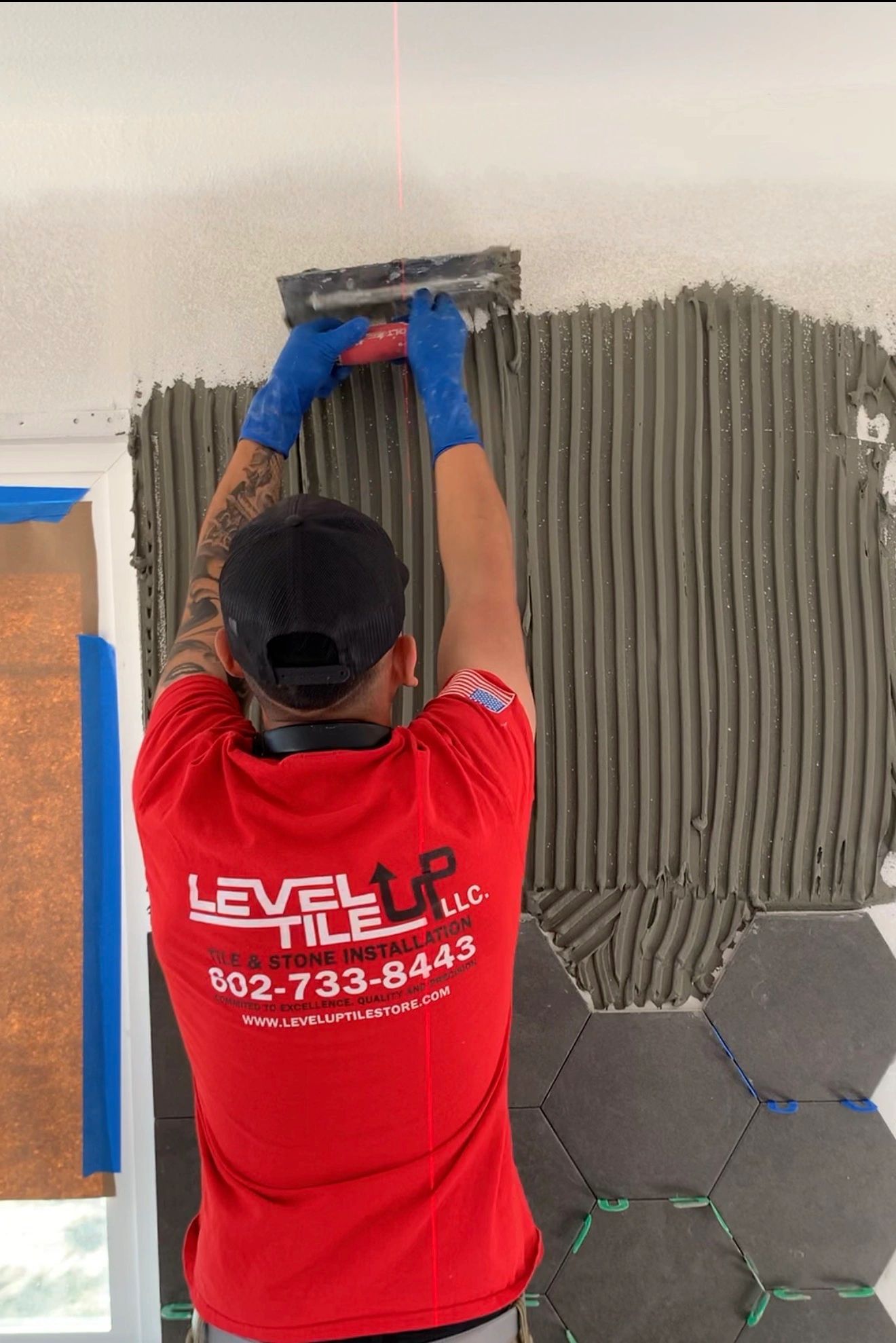 Felipe Maciel, owner of Level Up Tile LLC, installing tile in Peoria AZ