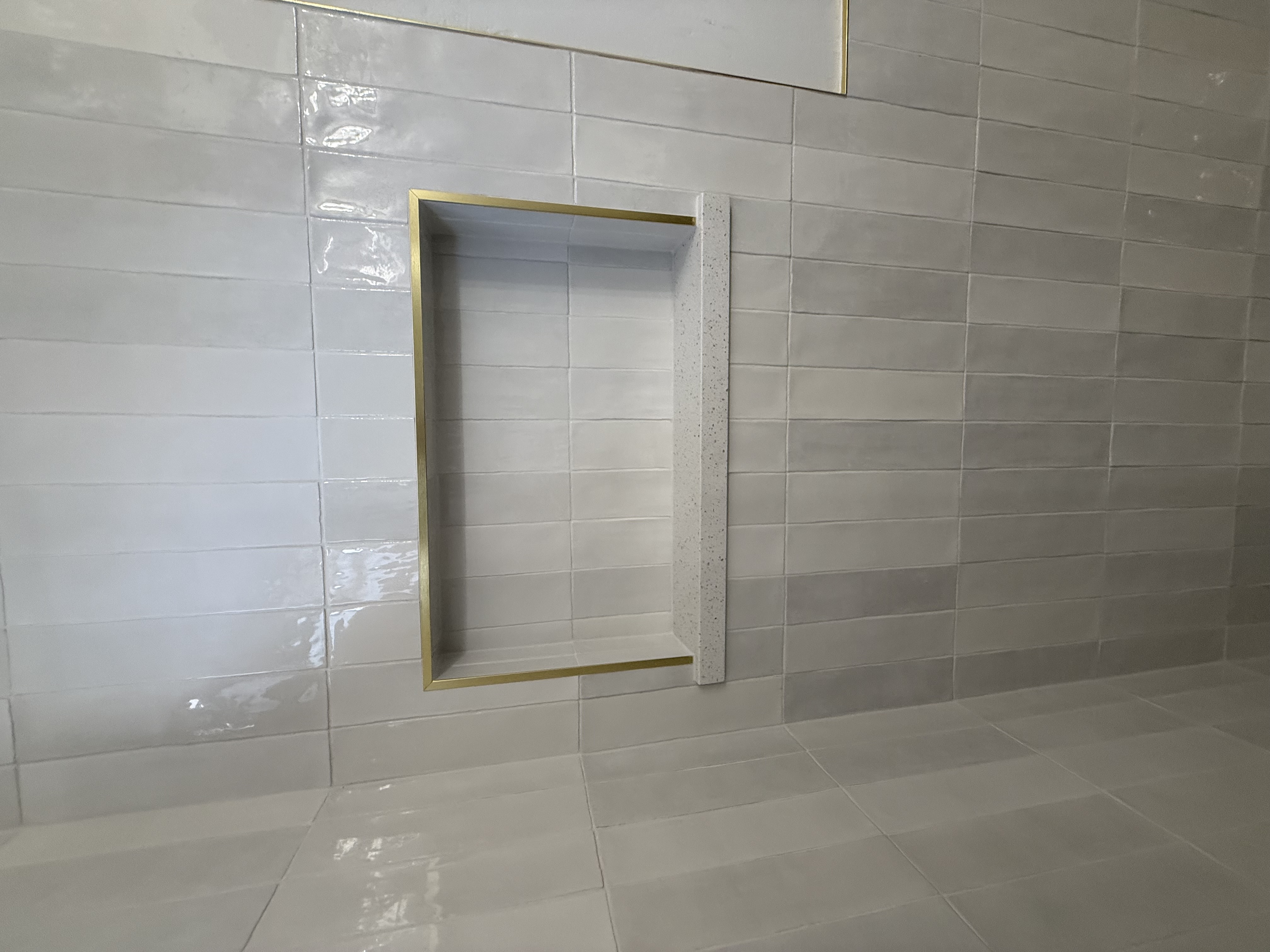 Zellige tile niche with gold trim by Level Up Tile