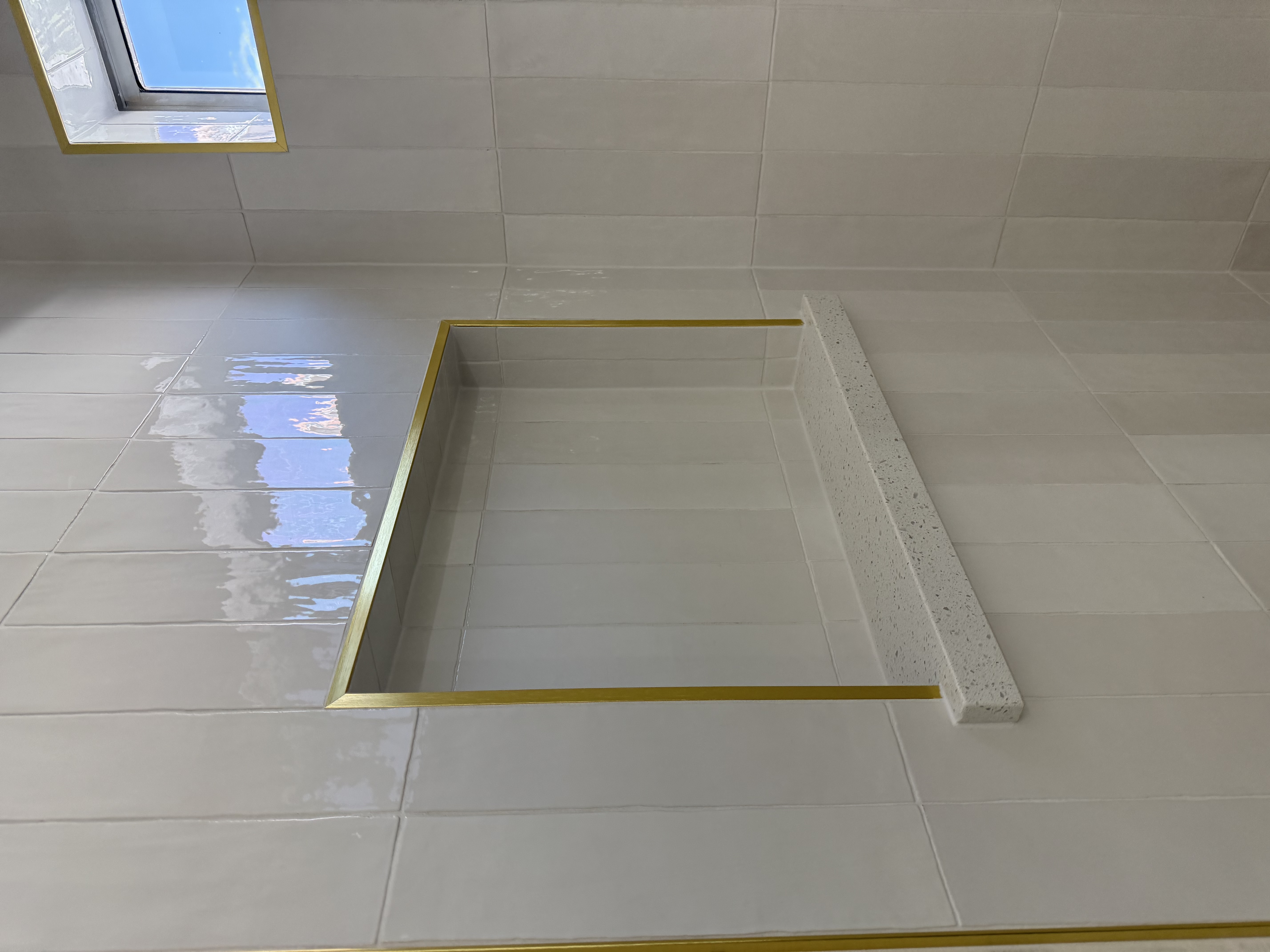 White Zellige tile niche with gold trim by Level Up Tile