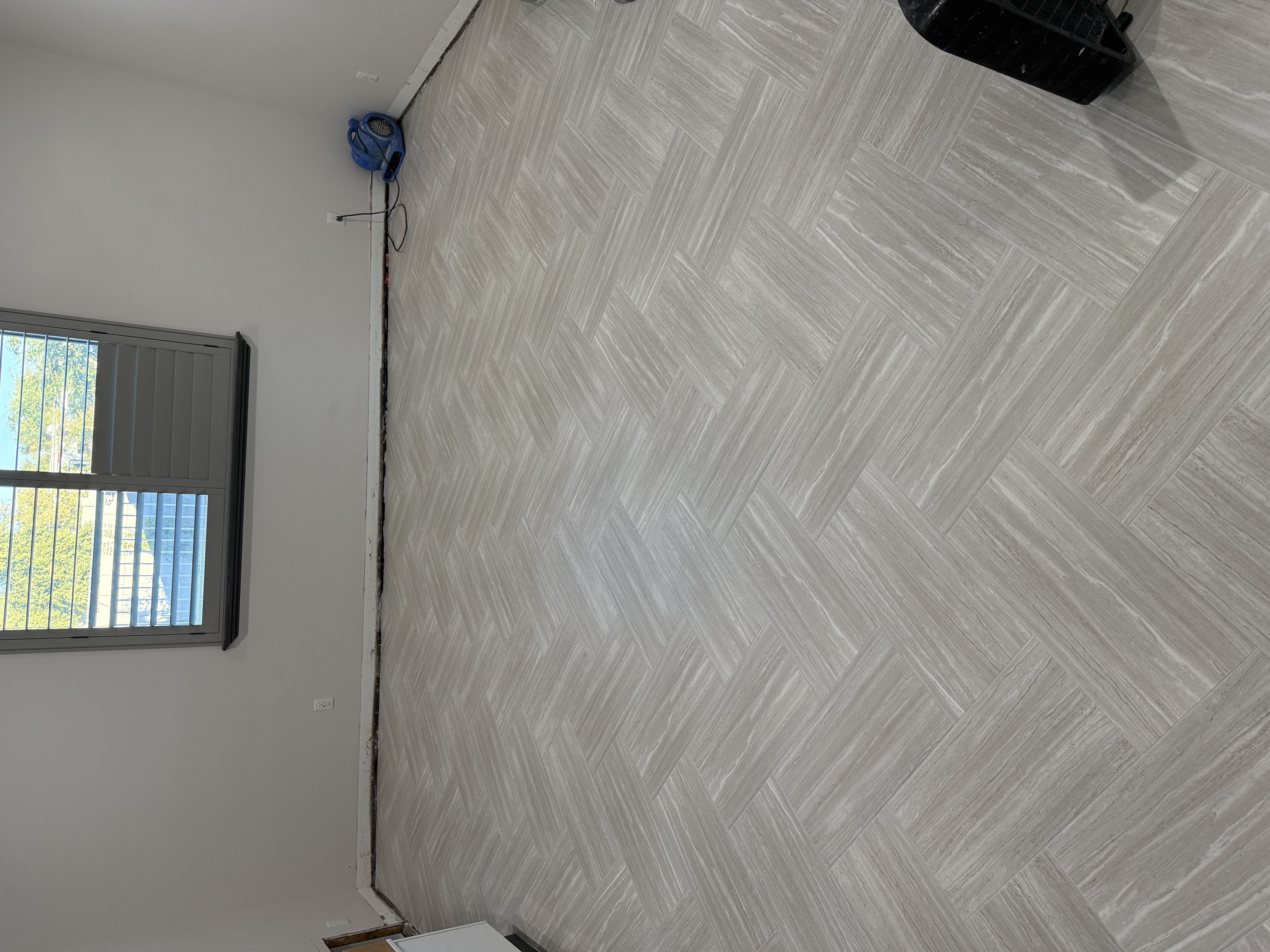 Gray herringbone tile flooring full room installation by Level Up Tile