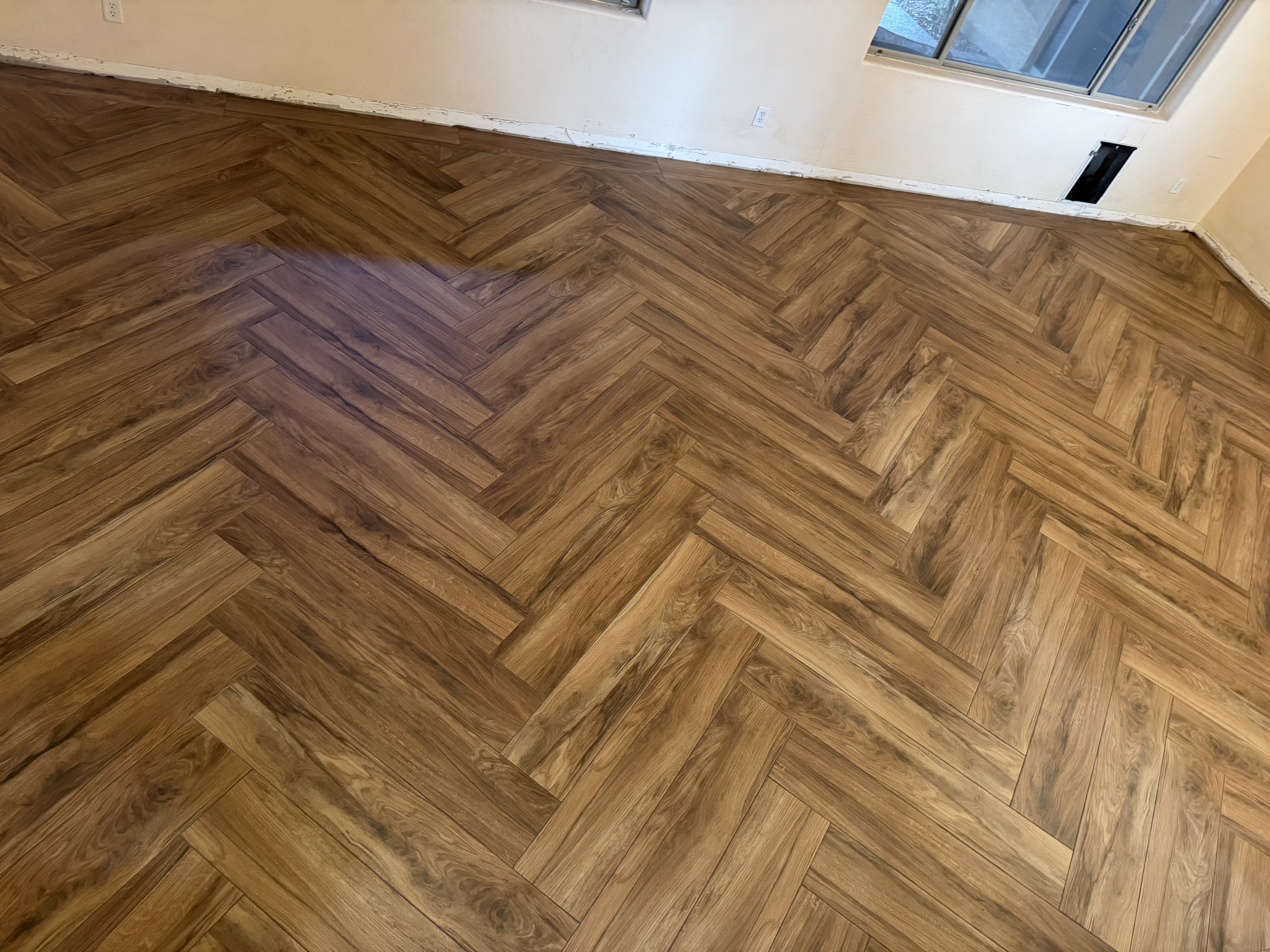 Herringbone wood-look tile flooring installed by Level Up Tile in Peoria AZ