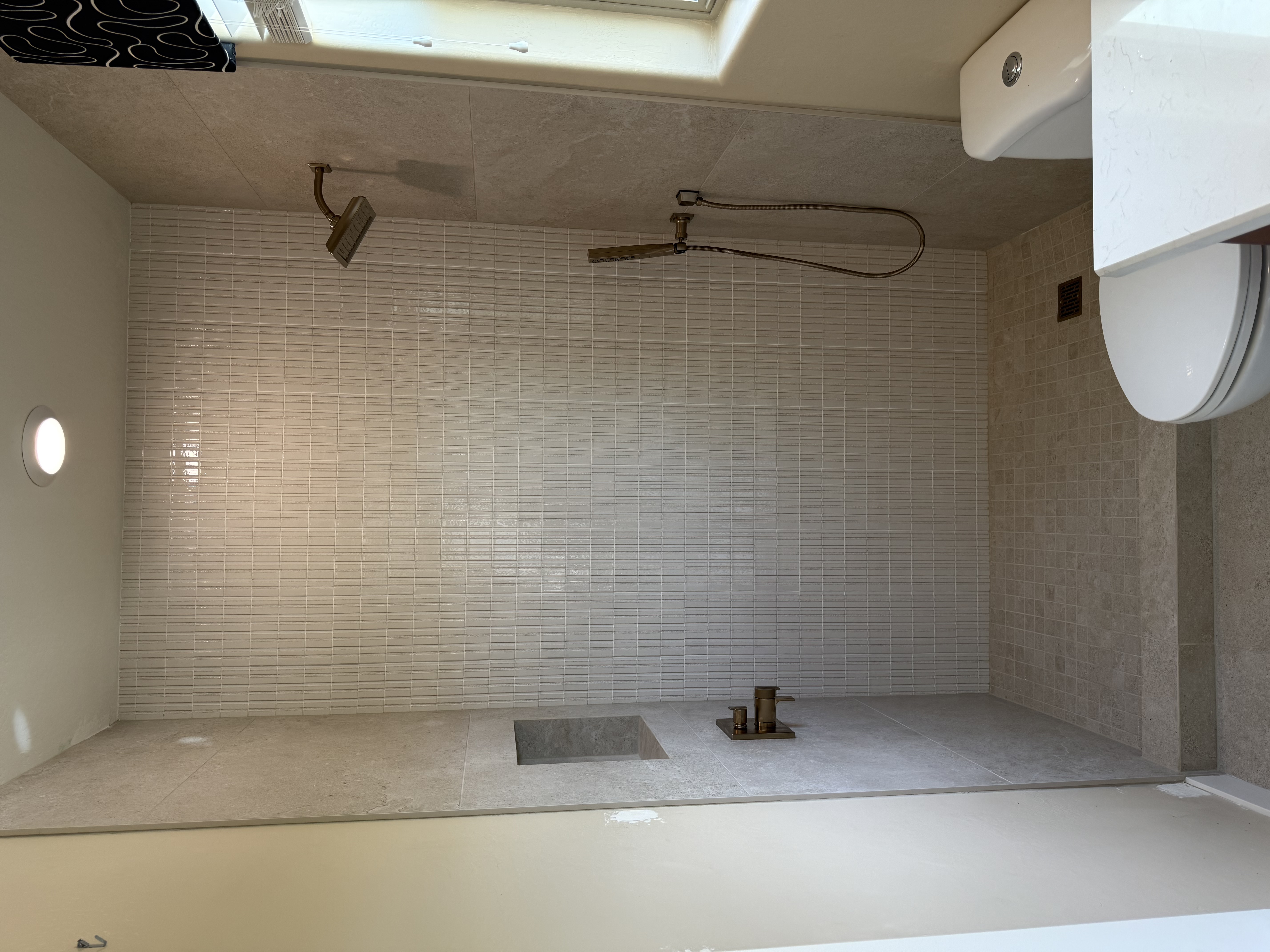 Linear tile accent wall shower with brushed nickel fixtures by Level Up Tile
