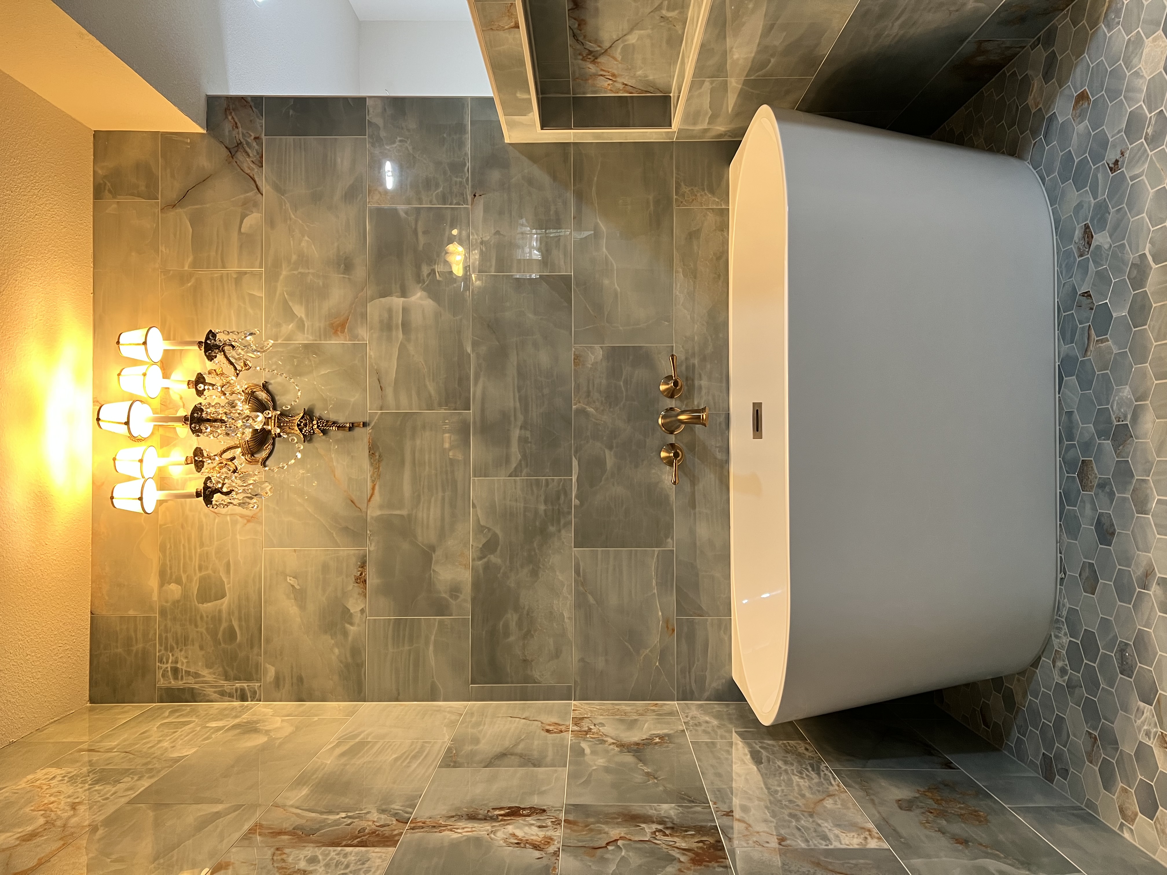 Luxury bathroom with freestanding tub and hexagonal accent tile by Level Up Tile in Scottsdale AZ