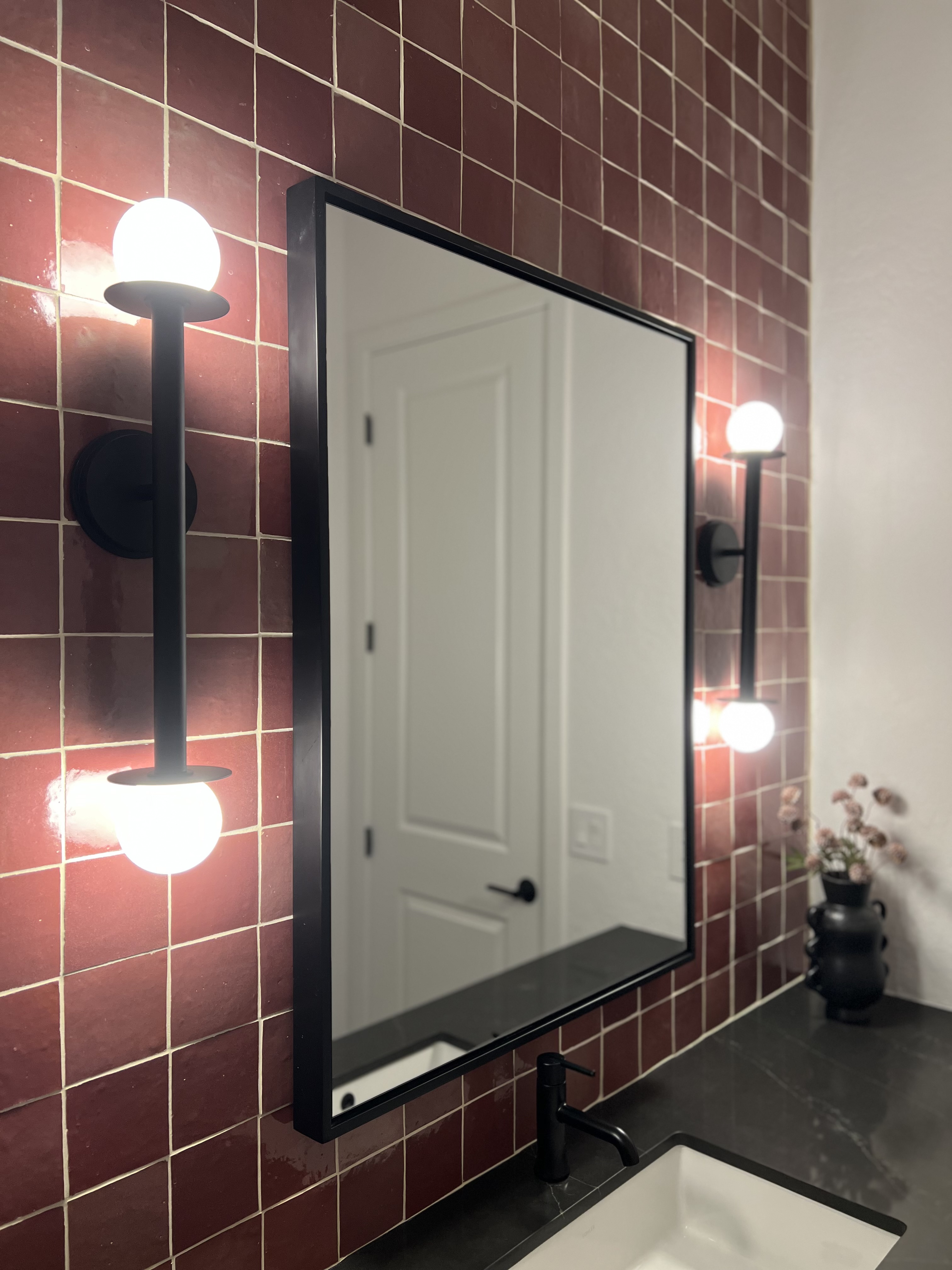 Red tile vanity wall with mirror and modern lighting by Level Up Tile
